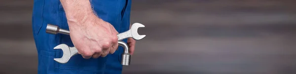 Hand of mechanic holding wrenches — Stock Photo, Image