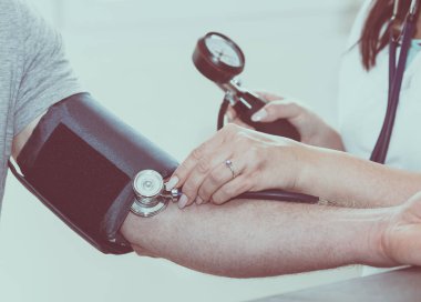 Doktor kan basıncını ölçüyor.