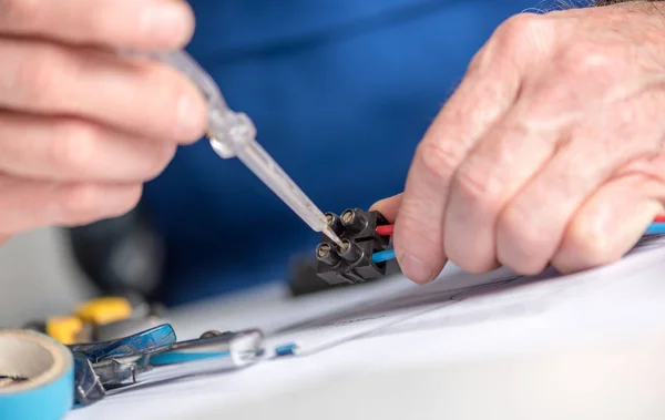 Electrician connecting wires in terminal block — Stock Photo, Image