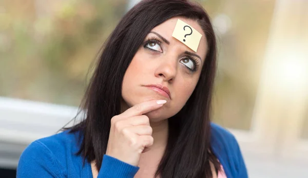Young woman with question mark on her forehead — Stock Photo, Image