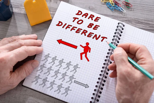 Dare to be different concept on a notepad