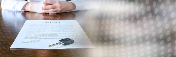 Female car buyer sitting in front of contract; panoramic banner — Stock Photo, Image