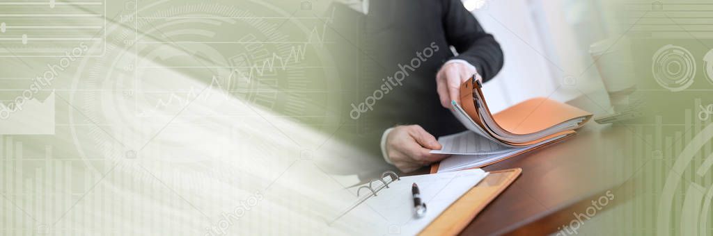 Businessman looking for document in folder; panoramic banner