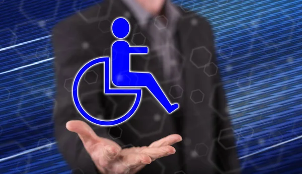 Disability insurance concept above the hand of a man in background