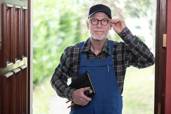 Portrait of repairman standing in the entrance of a house