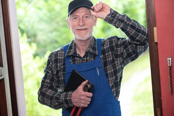 Portrait of repairman standing in the entrance of a house