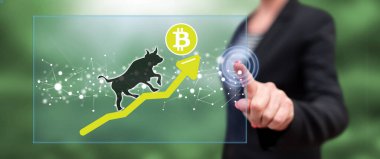 Dokunmatik ekranda parmaklarıyla bitcoin 'e dokunan bir kadın.