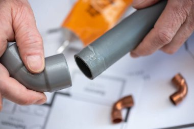 Plumber joining pvc pipe and fitting