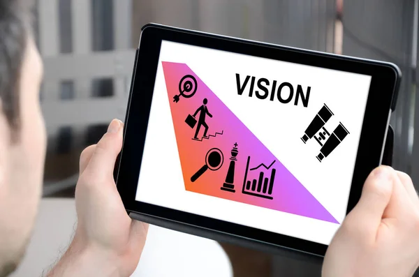 Man holding a tablet showing vision concept