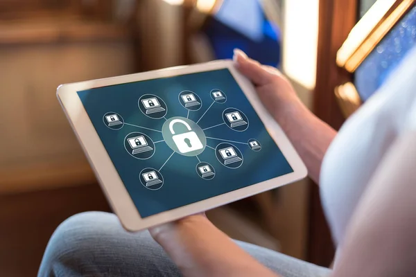 Woman holding a tablet showing cyber security concept