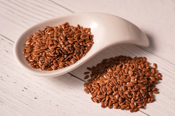 Flax Seed Close White Glass Dish Next Piled Table — Stock Photo, Image