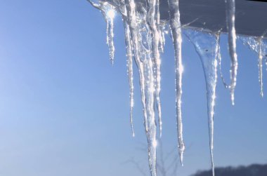 Resimde, mavi gökyüzüne karşı, sarkık sarkıtlar gösteriliyor..