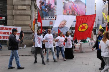 MILAN, ITALY - APRIL 15, 2017: PKK (Kurdish Workers' Party) sympathizers are demonstrating against president Erdogan at Cordusio Square for the freedom of Kurdish political prisoners in Turkey. clipart