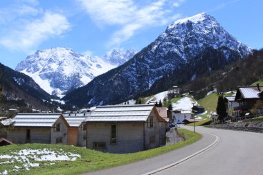 Brand, Bludenz, Vorarlberg, Avusturya - 30 Nisan 2017: Karlı Alp dağları olan şehir manzarası, tek ana caddeden alındı (Gufer Caddesi).