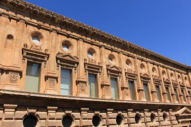 Exterior facade of historical Charles V Palace (Palacio de Carlos V) at the Alhambra Palace complex in Granada, Andalusia, Spain. clipart