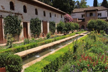 Granada, Endülüs, İspanya - 29 Temmuz 2017: Tarihsel Alhambra sarayı ve kale kompleksindeki Genelkurmay bahçelerinin (Palacios del Generalife) Su Hendeği (Patio de la Acequia) avlusu.