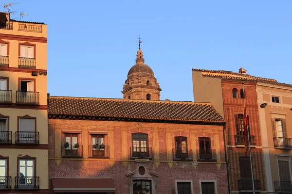 Traditional buildings of Malaga city at sundown in Andalusia, Spain.