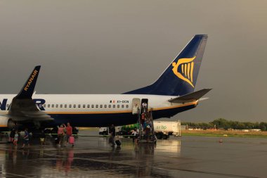 Memmingen, Almanya - 24 Temmuz 2017: Yolcular Allgau havaalanında yağmurlu bir günde Ryan Air uçağından indiler.