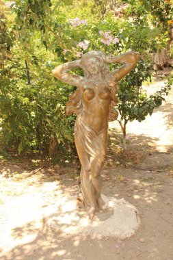 CHANIA, CRETE ISLAND, GREECE - JULY 28, 2016: A naked, long haired woman statue at Botanical Park and Garden of Crete. 