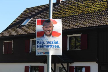 HARD, VORARLBERG, AUSTRIA - September 15, 2019: The election poster of Norbert Hofer who is the candidate of Freedom Party of Austria (FPO) for the general election on 29. September 2019, Uferstrasse. clipart