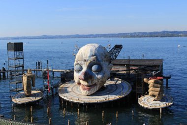 BREGENZ, VORARLBERG, AUSTRIA - SEPTEMBER 15, 2019: Floating open-air theater stage with a colossal head and two hands, ready for the next opera 