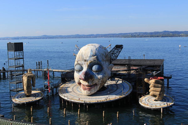 BREGENZ, VORARLBERG, AUSTRIA - SEPTEMBER 15, 2019: Floating open-air theater stage with a colossal head and two hands, ready for the next opera "Rigoletto" by Giuseppe Verdi.