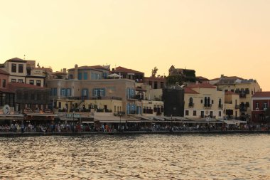 CHANIA, CRETE ISLAND, GREECE - JULY 28, 2016: A view of old Venetian Harbor with historical buildings.