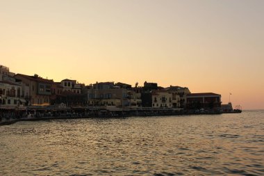 CHANIA, CRETE ISLAND, GREECE - JULY 28, 2016: A view of old Venetian Harbor with historical buildings.