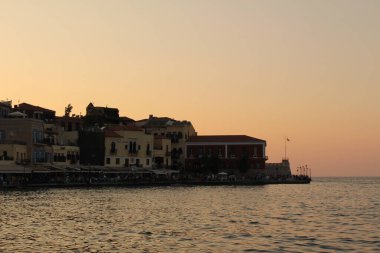 CHANIA, CRETE ISLAND, GREECE - JULY 28, 2016: A view of old Venetian Harbor with historical buildings.