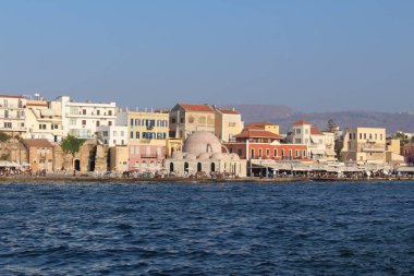 CHANIA, CRETE ISLAND, GREECE - AUGUST 4, 2016: A view of old Venetian Harbor with historical buildings.