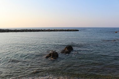 Mediterranean sea waves splashing at the rocks with foam in Chania, Crete Island, Greece.