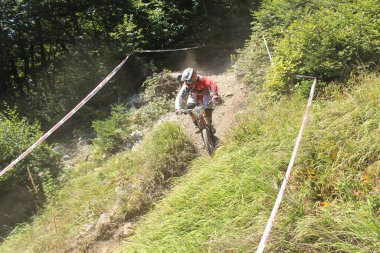 INNSBRUCK, AUSTRIA - 29 Ağustos 2015: Nordkette Alp dağ zincirinde Nordkette Downhill Pro yarışması sırasında tam donanımlı profesyonel motorcu dağ bisikleti sürüyor.