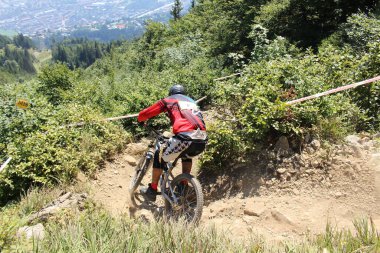INNSBRUCK, AUSTRIA - 29 Ağustos 2015: Nordkette Alp dağ zincirinde Nordkette Downhill Pro yarışması sırasında tam donanımlı profesyonel motorcu dağ bisikleti sürüyor.