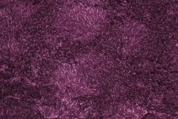 Purple fluffy carpet texture of textile for blank and pure backgrounds