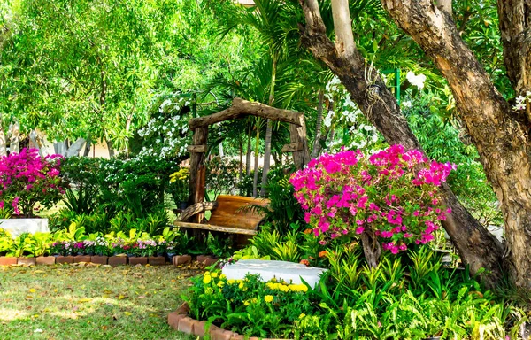 Wood chair in the flowers garden. — Stock Photo, Image