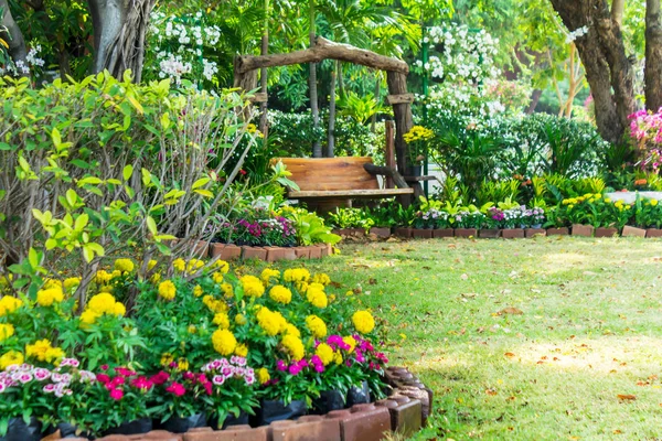 Wood chair in the flowers garden. — Stock Photo, Image