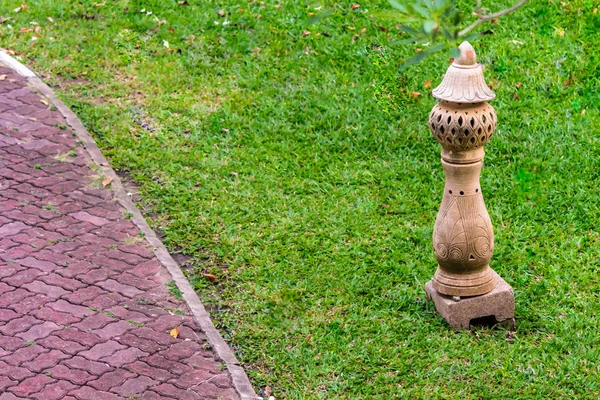 Carved stone lamp decoration in garden. — Stock Photo, Image