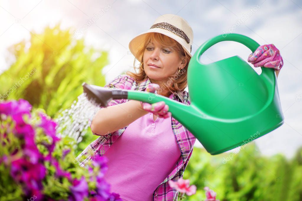 Gardener taking care of her plants in a garden