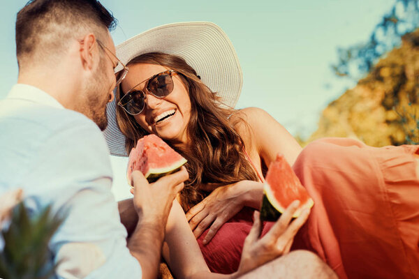 Laughing couple having picnic in countryside