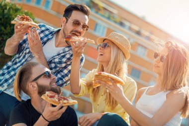 Kendi dilim pizza alarak arkadaş grubu.