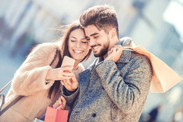 Beautiful young loving couple in shopping — Stock Photo, Image