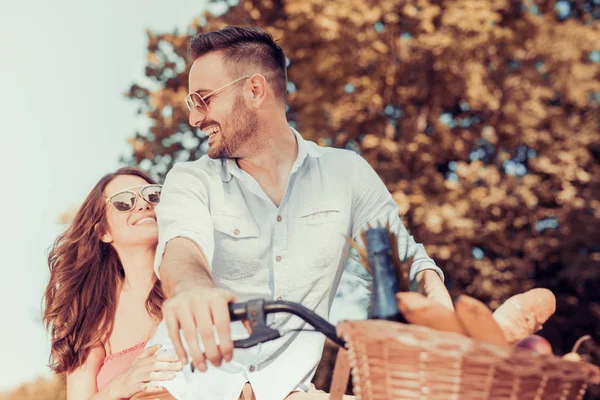 Young couple riding on the bicycle — Stock Photo, Image
