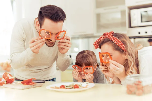 Happy young family preparing lunch