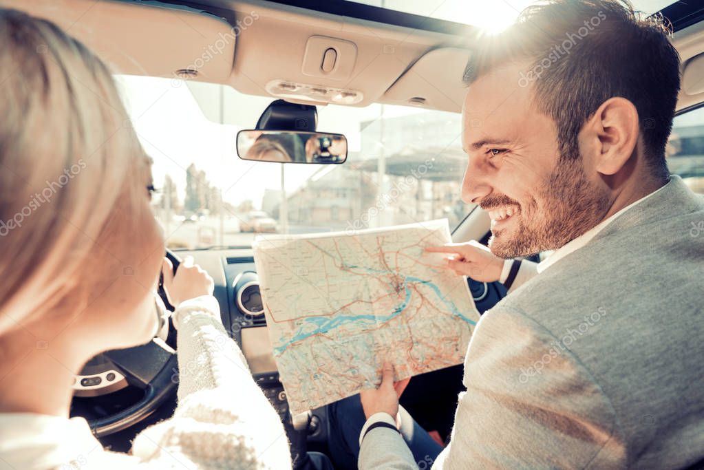 Happy young couple traveling by car on vacation