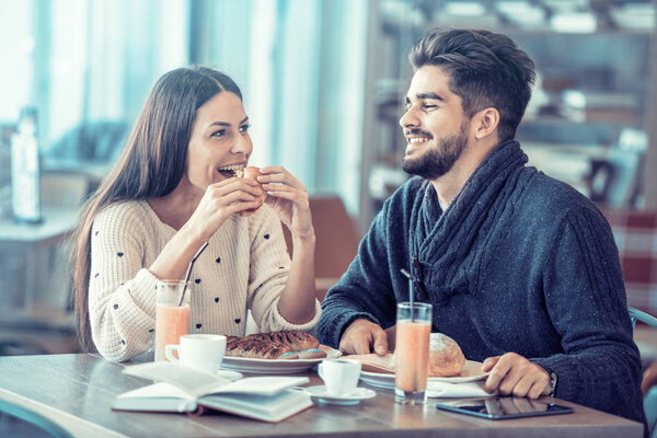 Happy morning,young couple having breakfast in cafe