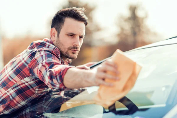 Junger Mann putzt sein Auto im Freien — Stockfoto