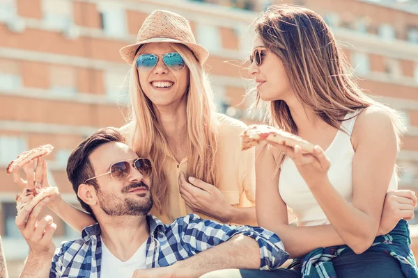 Group of friends taking their slices of pizza — Stock Photo, Image