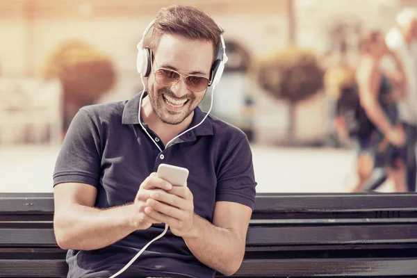 Man is smiling while wearing headphones — Stock Photo, Image