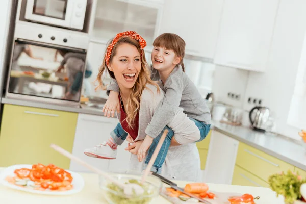 Girl and mother cooking in the kitchen — Stock Photo, Image