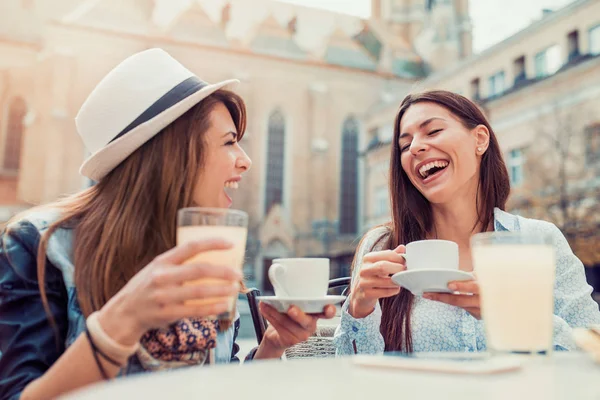 Young girls sitting in a cafe — Stock Photo, Image